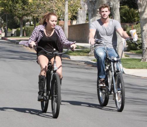 Miley Cyrus and boyfriend Liam Hemsworth go for a bike ride through her Toluca Lake, CA neighborhood